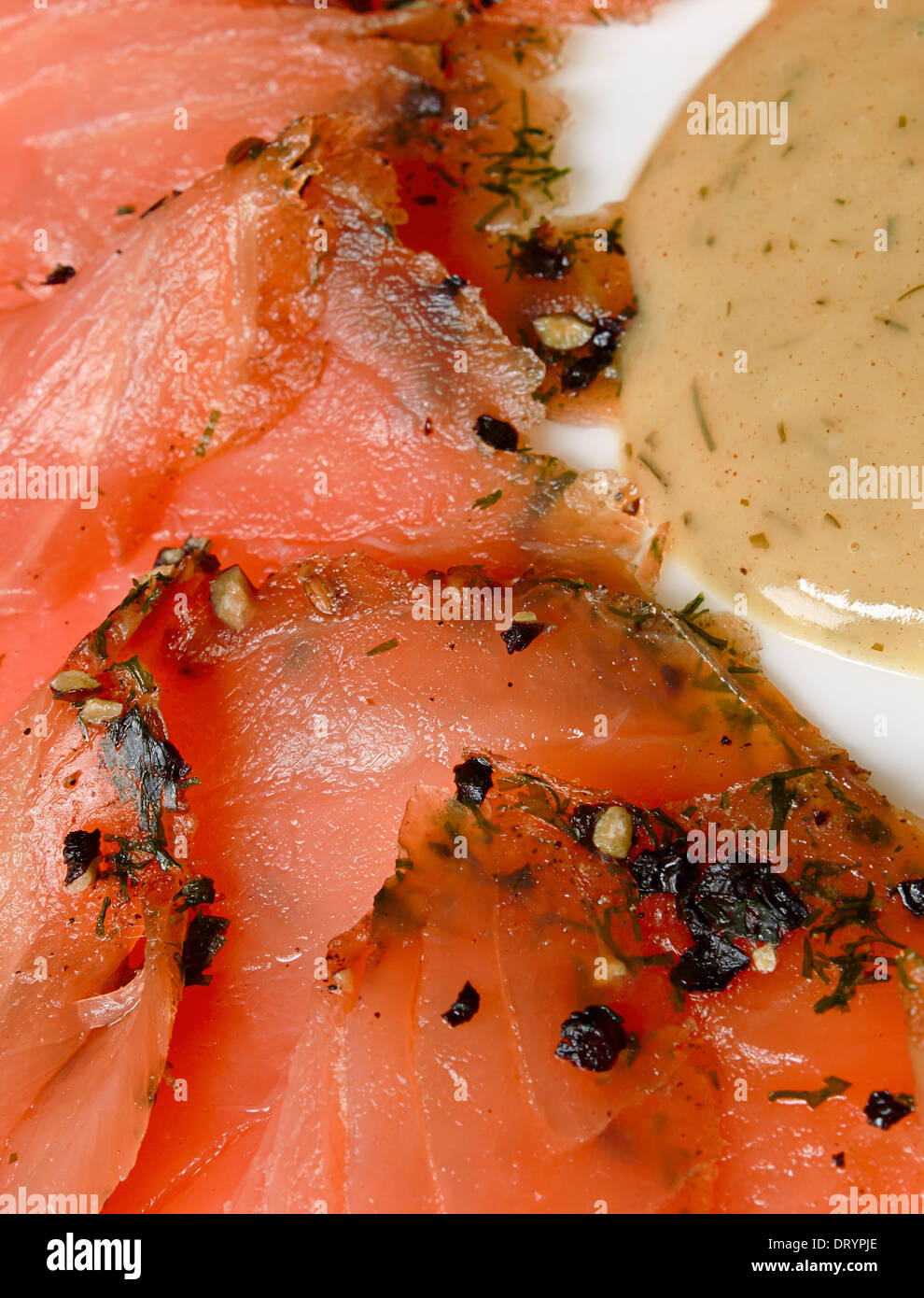 Gravlax salmon slices served with a mustard and dill sauce. Stock Photo