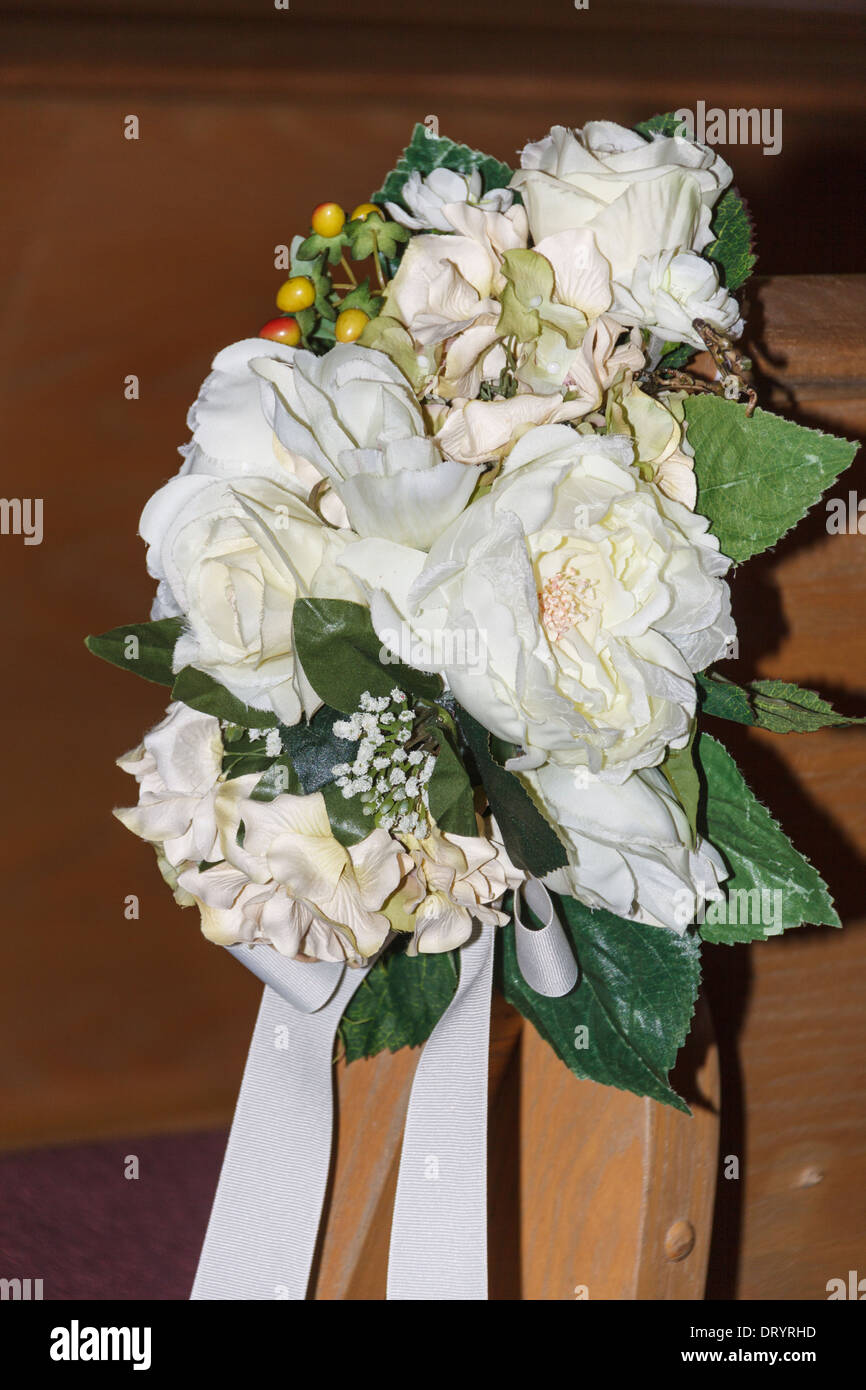 Wedding bouquet on pew in Heather's Glen wedding chapel in Conroe, Texas. Stock Photo