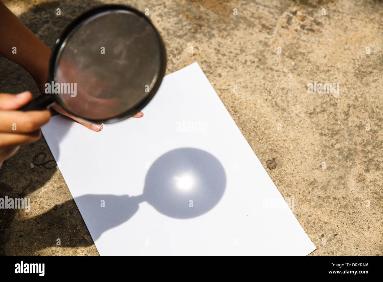 Scientific experiments. Use a magnifying glass to light the White Paper