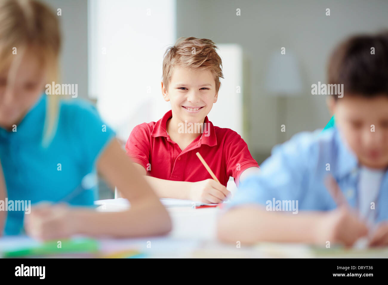 Portrait of cute schoolboy looking at camera at drawing lesson Stock ...