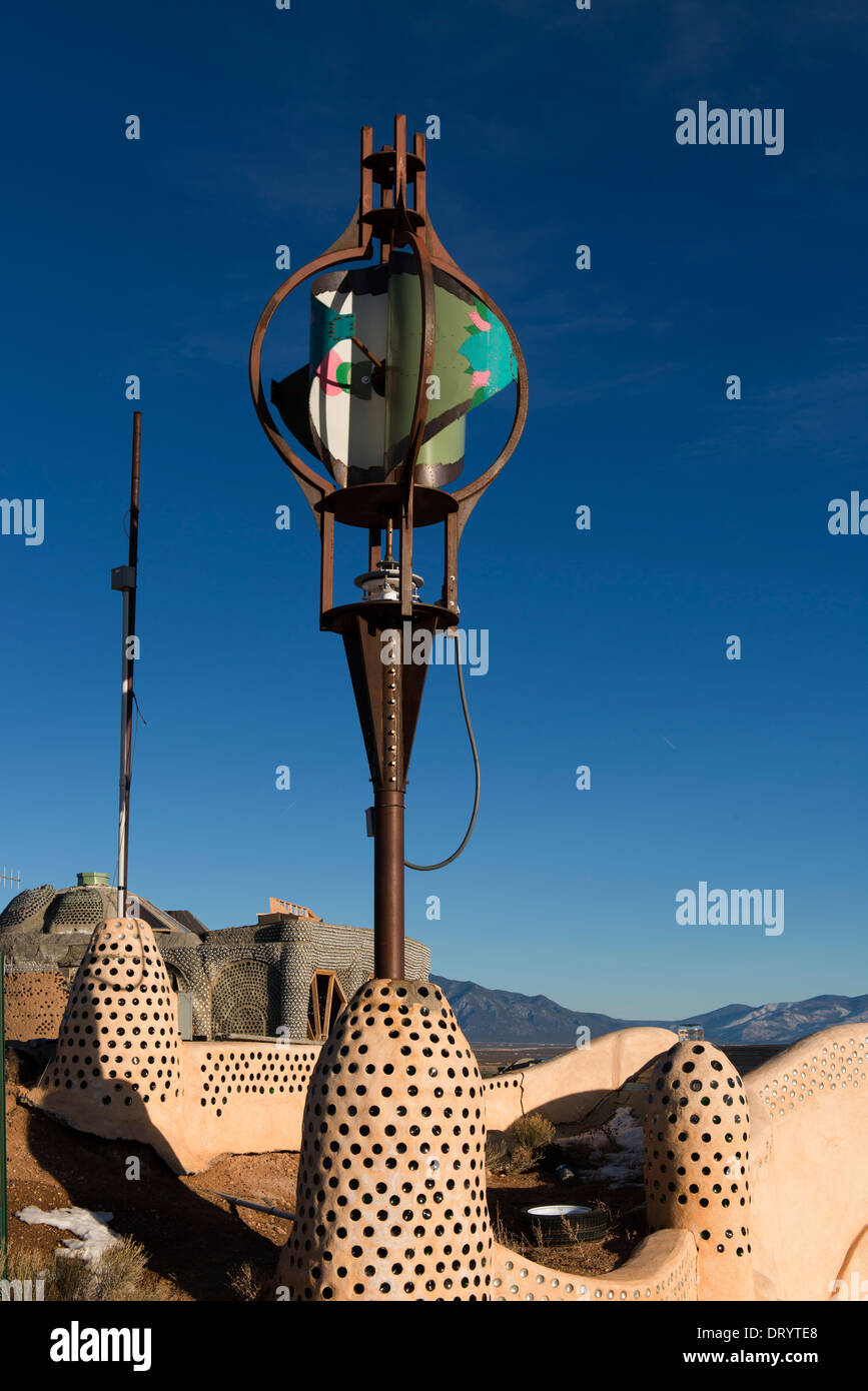 Earthship alternative construction with recycled material showing wind generator. Stock Photo