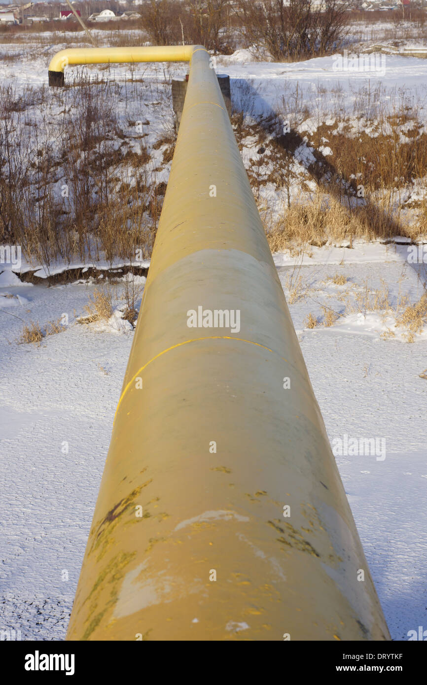 Pipeline across frozen river Stock Photo