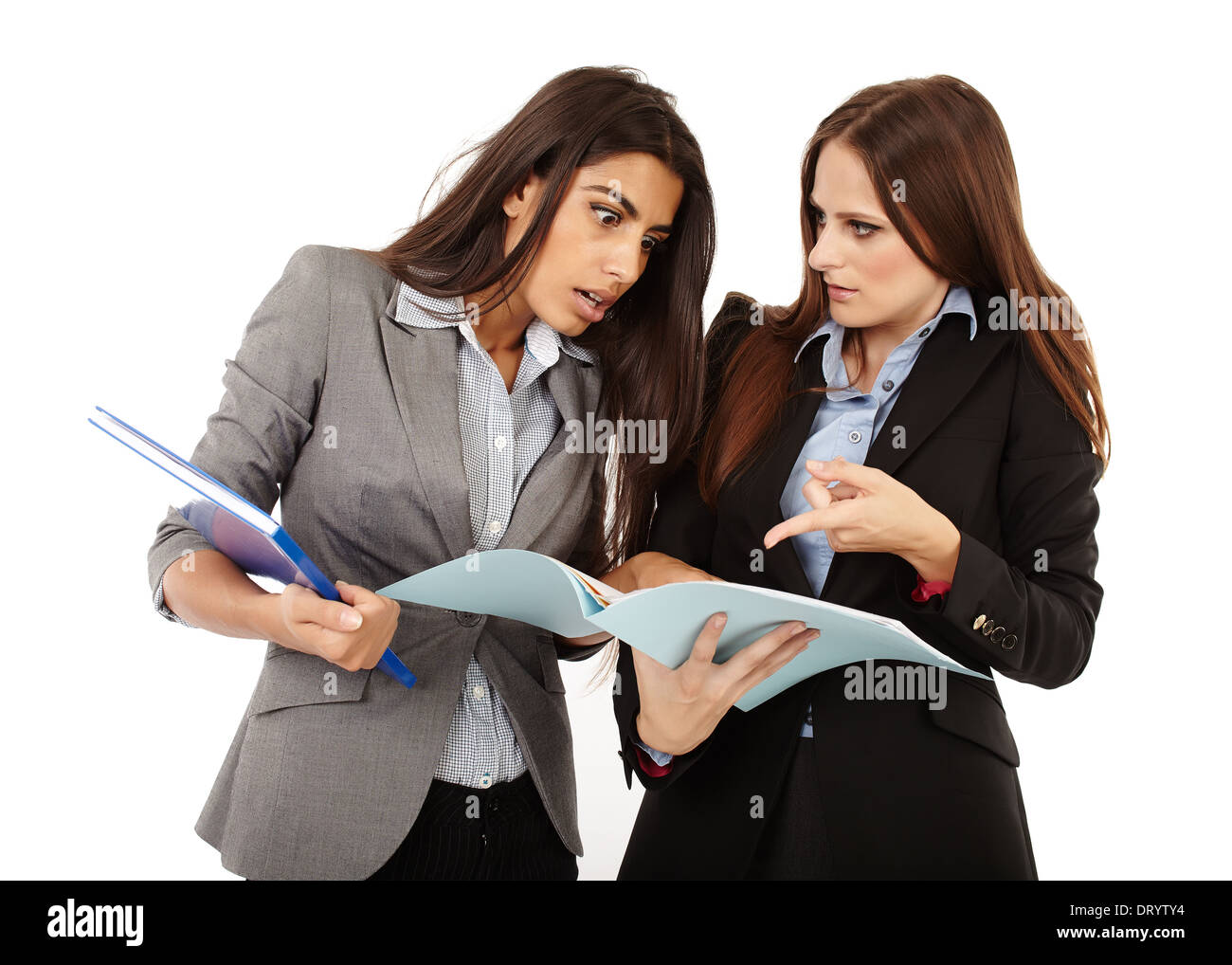 Two successful businesswomen discussing and looking to documents isolated on white Stock Photo