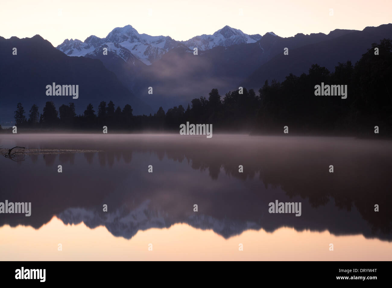 Sunrise over the Southern Alps from Lake Matheson, Westland, New Zealand. Stock Photo