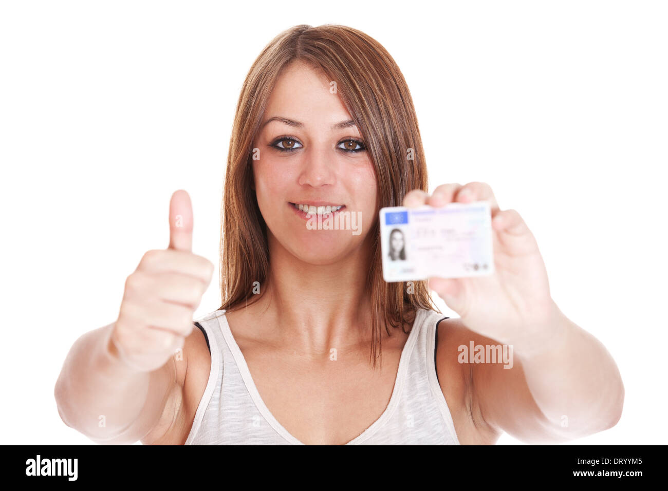 Attractive girl proudly showing her drivers licence. All on white background. Stock Photo