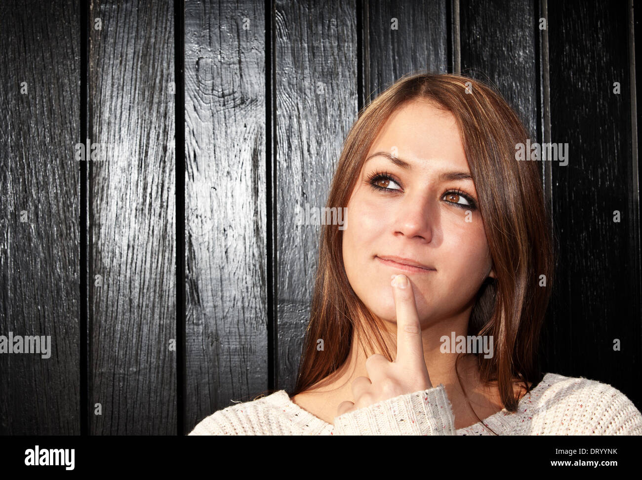 Attractive woman deliberates decision. Stock Photo