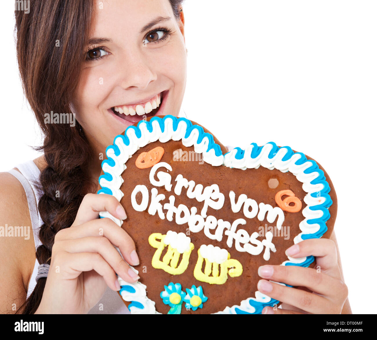 Attractive woman bites into gingerbread heart from the Oktoverfest Stock Photo