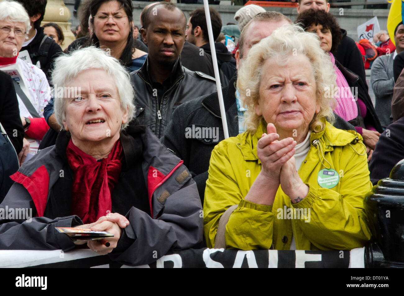 TWO ELDERLY LADY HARKEN THE SPEAKER ON THE STAGE AGAINST PUBLIC SPENDING CUTS Stock Photo