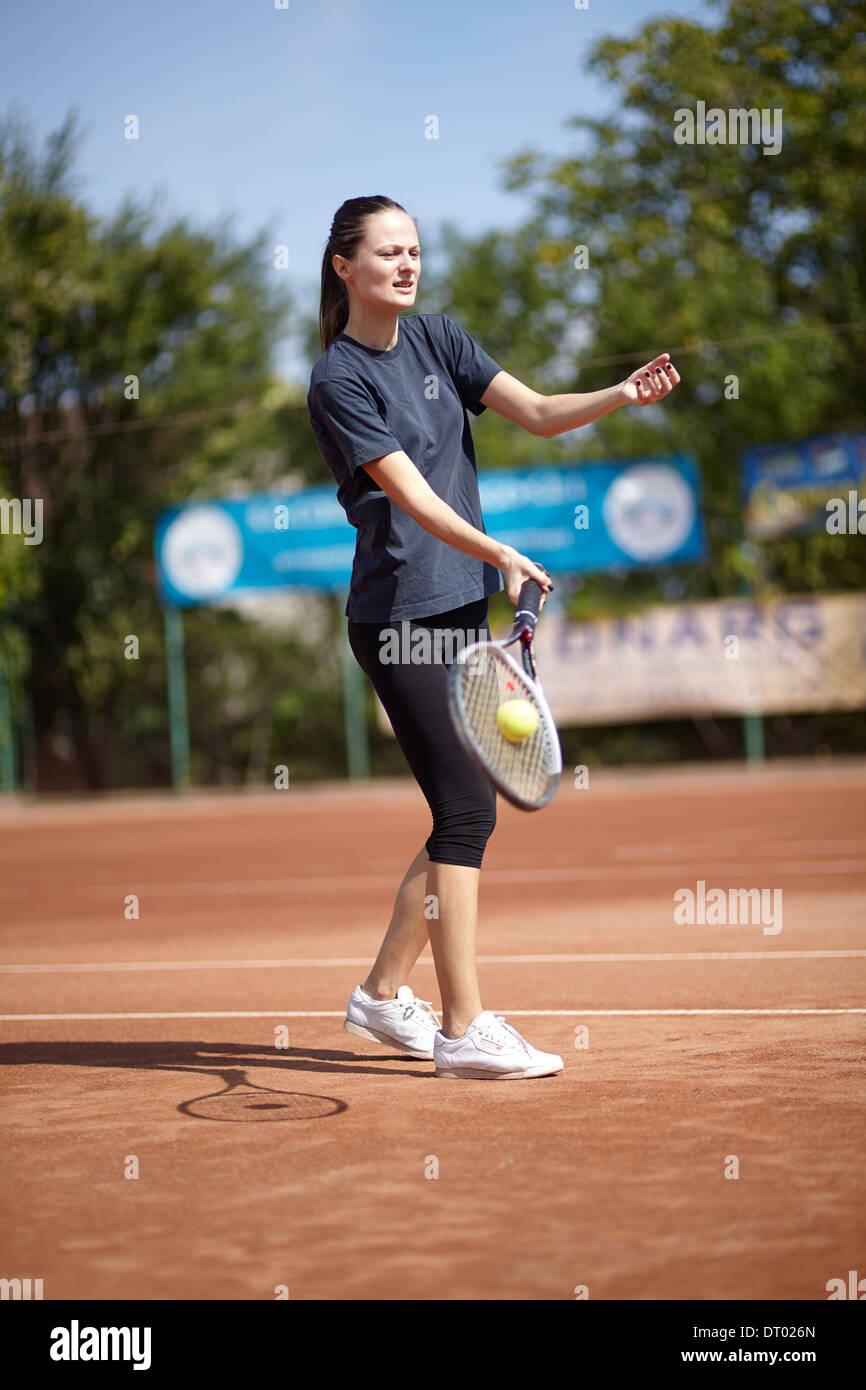 Female tennis player executing a forehand volley Stock Photo