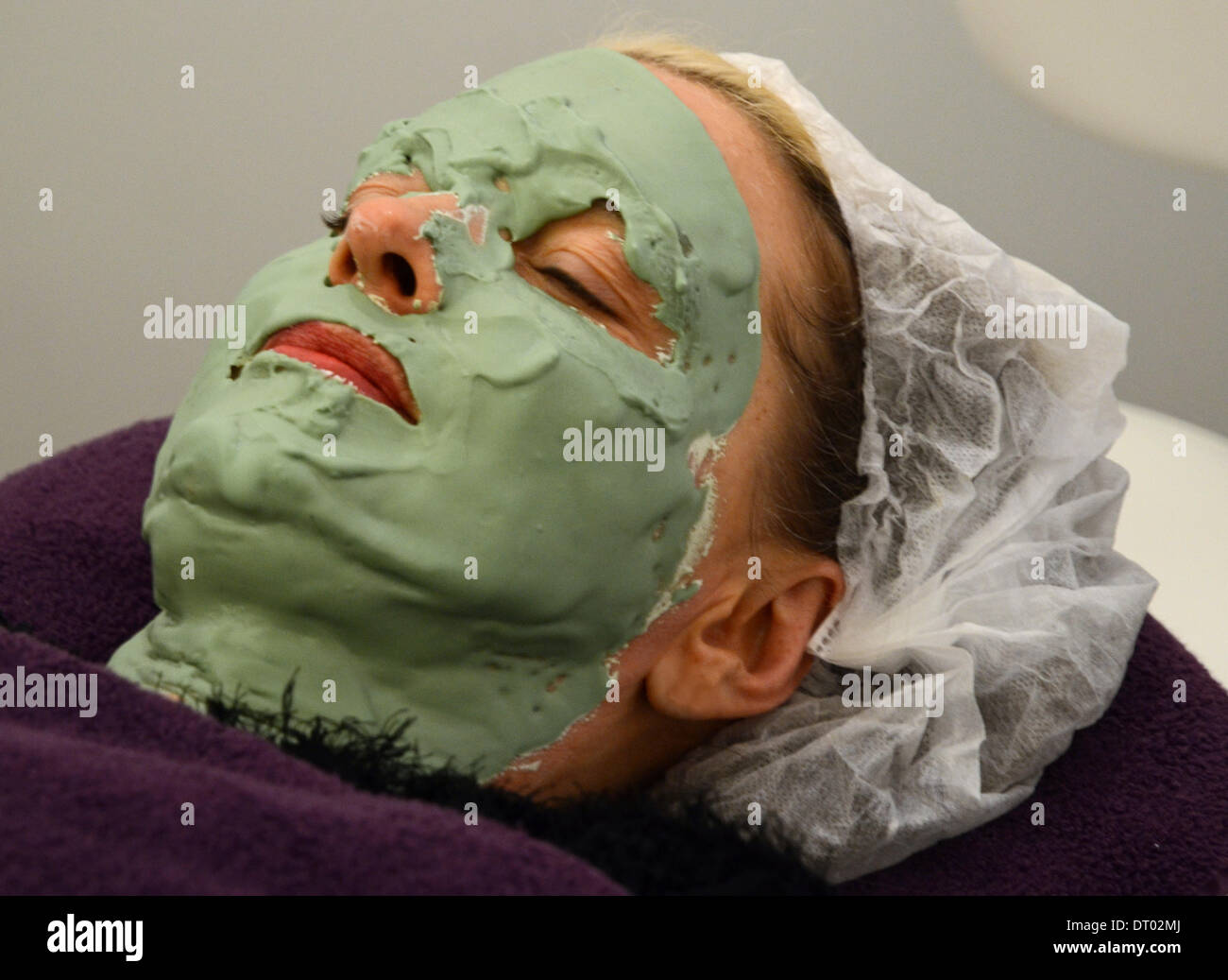 A woman with a green face mask at the Lifetime-Beauty Fair in Dusseldorf, North Rhine-Westphalia, on 1 February 2014. Stock Photo