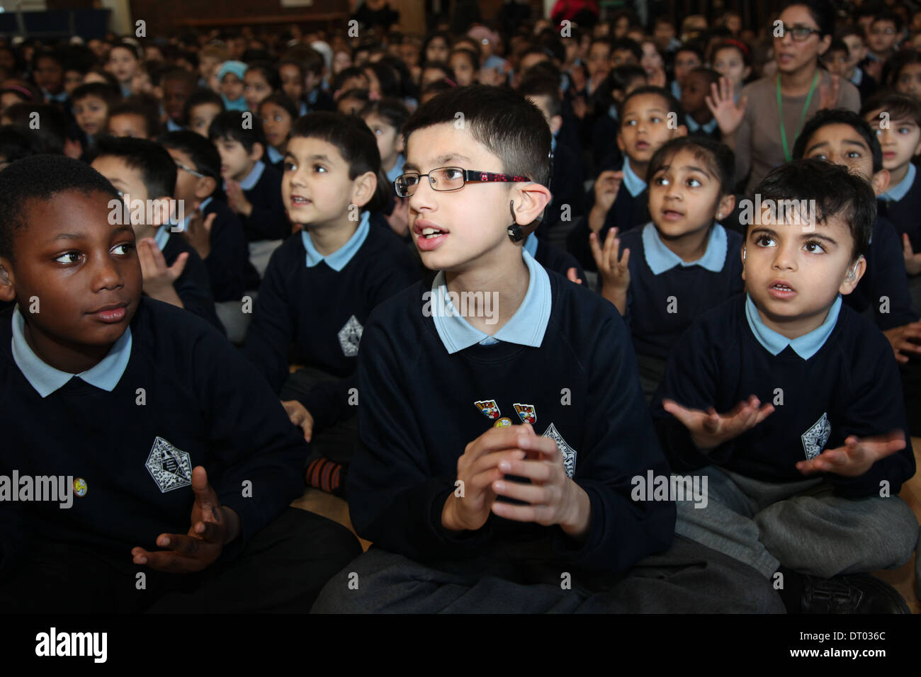 Children singing and performing sign language at a school assembly