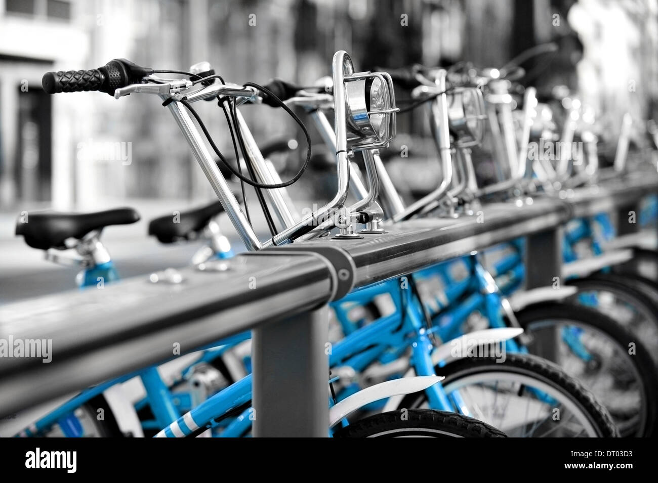 Urban scene with blue bicycles for rent in a velo station Stock Photo