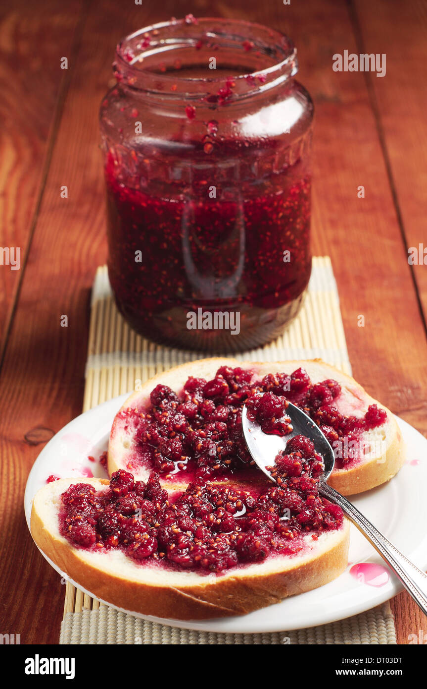 White bread and glass jar with raspberry jam Stock Photo - Alamy