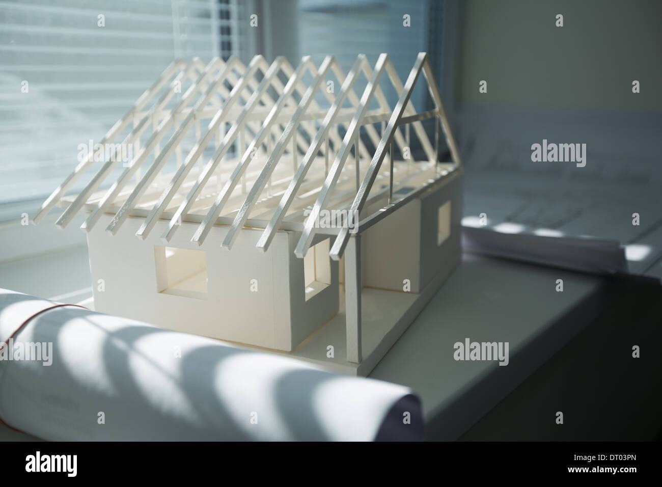 Model of a house made from paper standing at the window Stock Photo