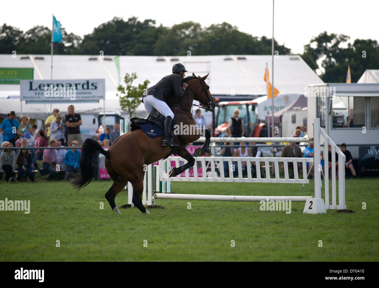 A horse and rider approaching a fence in the show jumping competition ...