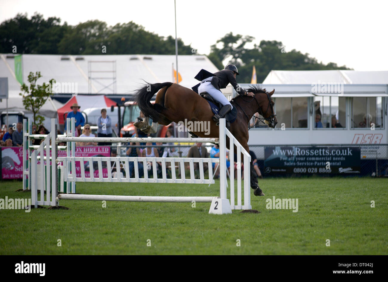 A horse and rider safely over a fence in the show jumping competition ...