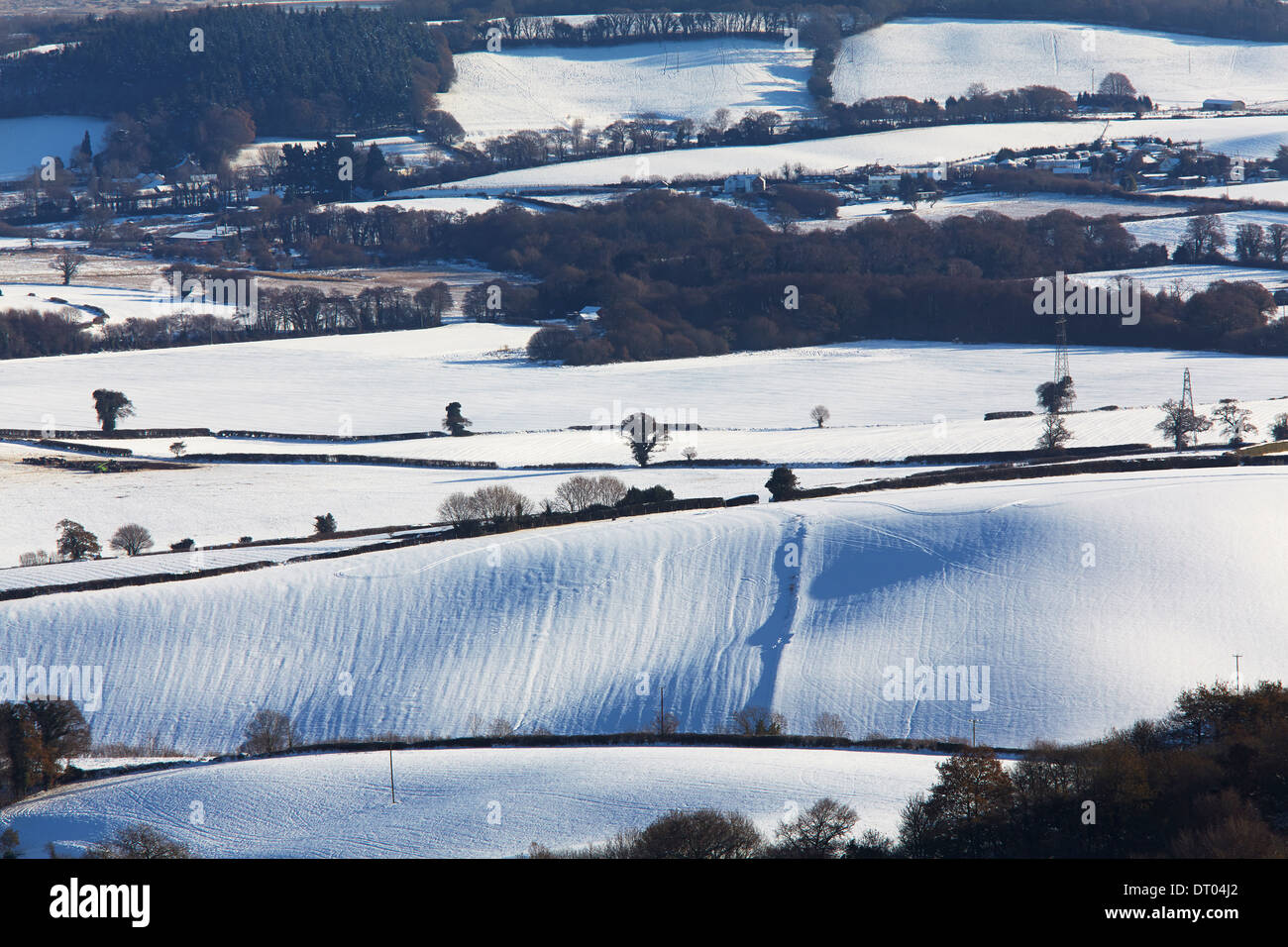 Rolling, snow-covered farmland, seen from Mamhead in the Haldon Hills, near Exeter, south Devon, Great Britain. Stock Photo