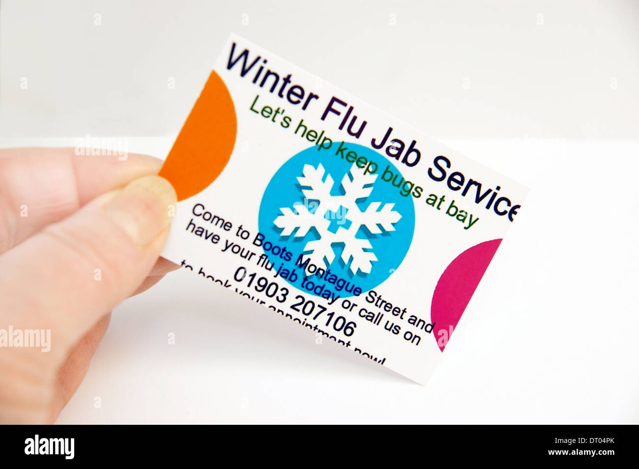 Boots the Chemist winter flu jab service information card in the pharmacy department recommending to book up an appointment Stock Photo