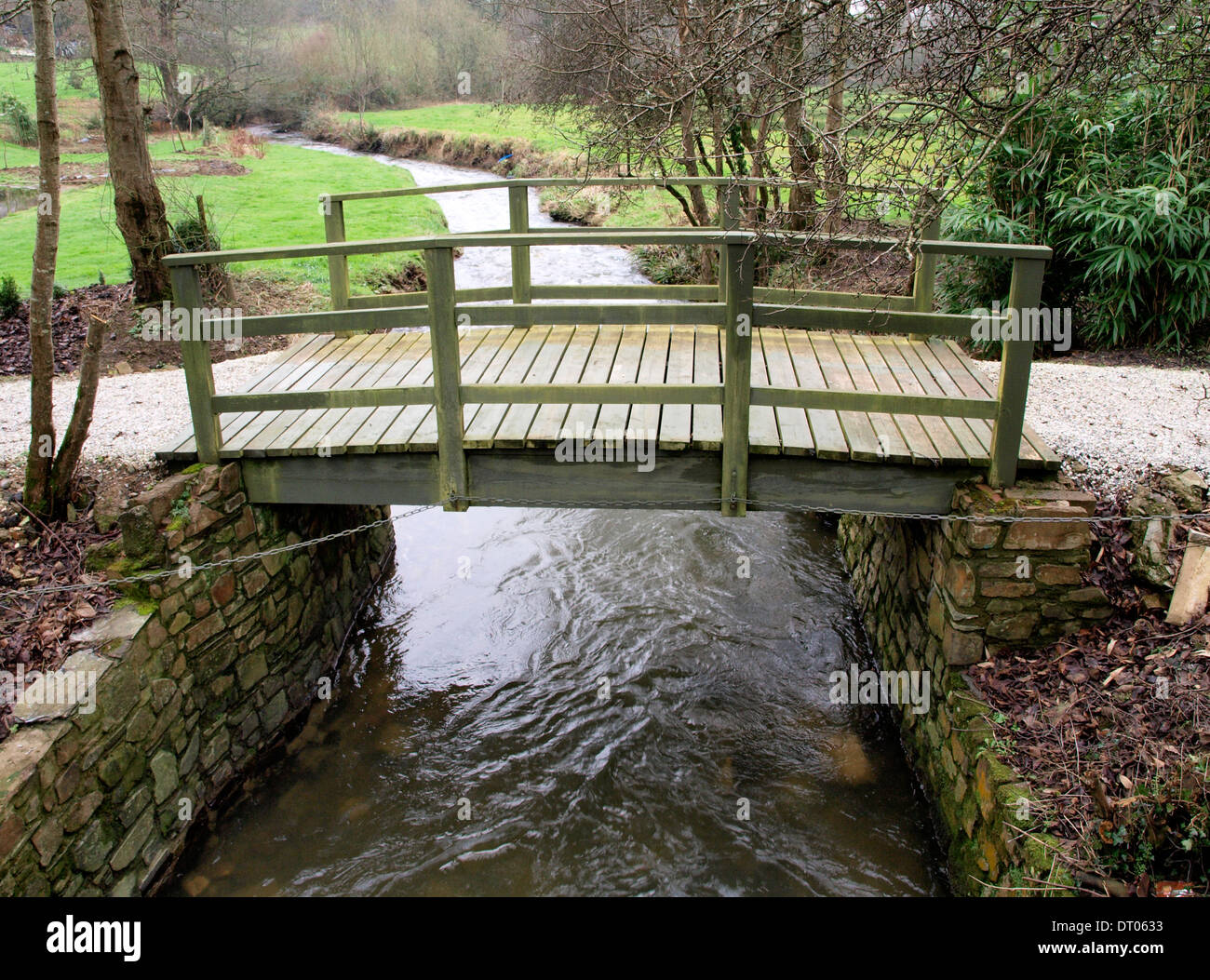 Small wooden bridge over river, Cornwall, UK Stock Photo