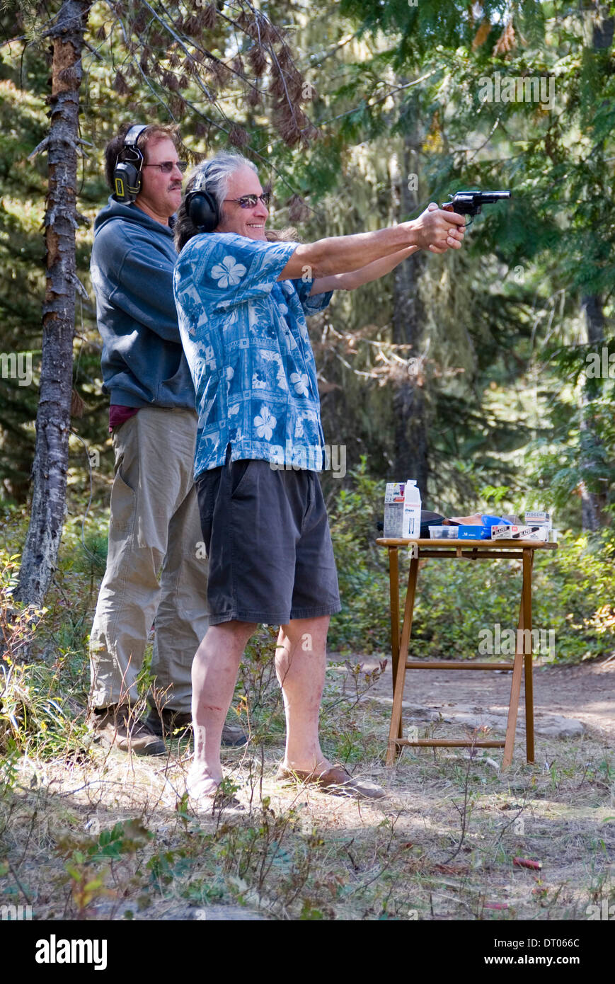American men shooting at trees for target practice in the Okanogan