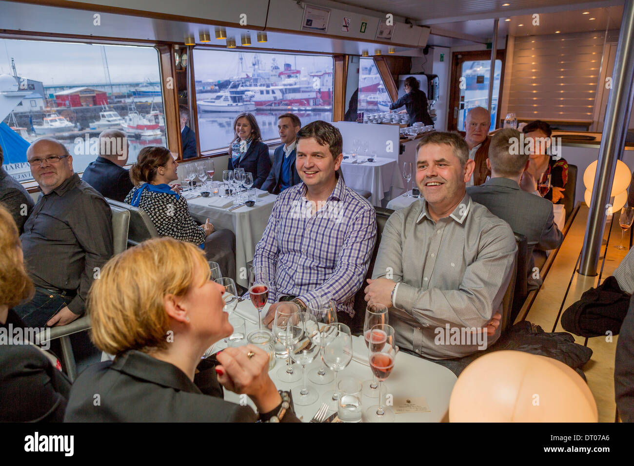 People  enjoying a dinner cruise around Reykjavik Harbor, Reykjavik, Iceland Stock Photo