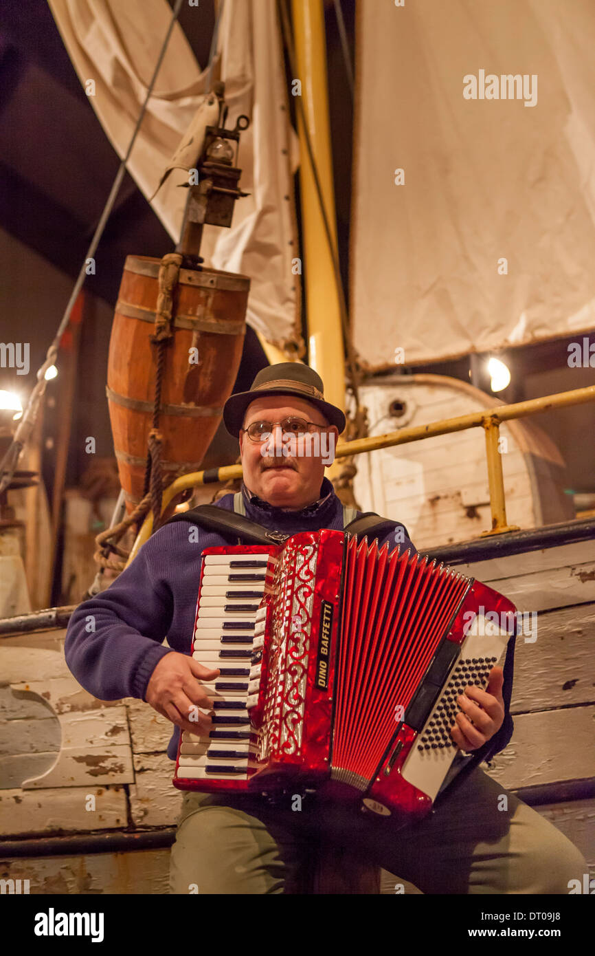 Man playing the accordion by The Herring Era Museum in Siglufjordur, Iceland. Stock Photo