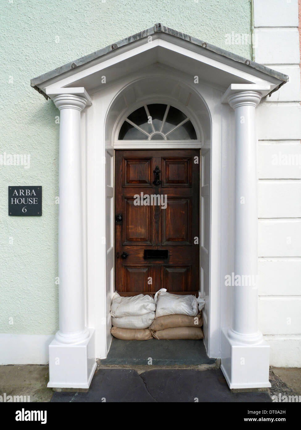 Door in Georgian house doorway with sandbags flood prevention in Aberaeron, Ceredigion Wales UK 2014 KATHY DEWITT Stock Photo