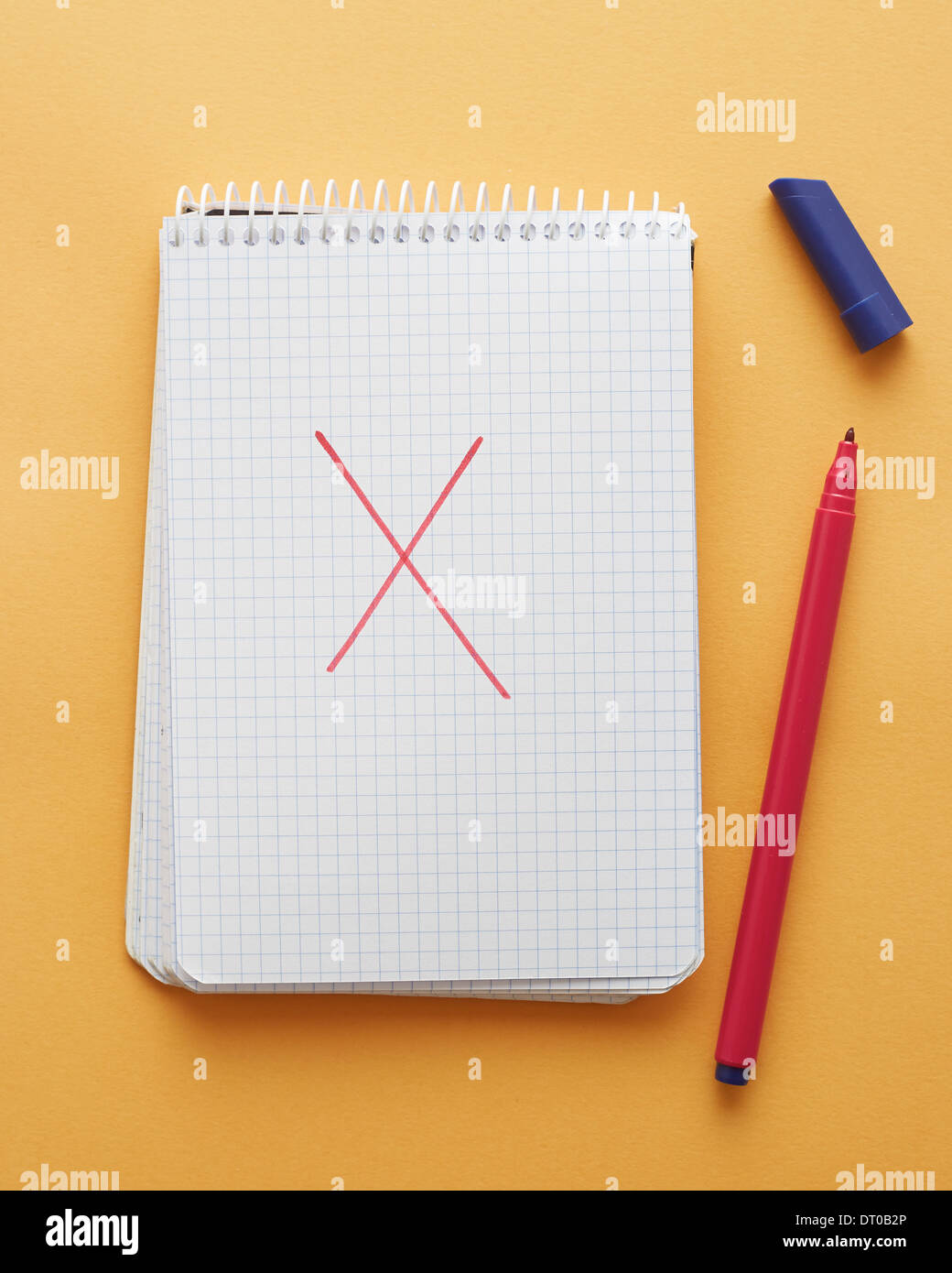 X letter handwritten in notebook page on yellow background alphabet Stock Photo