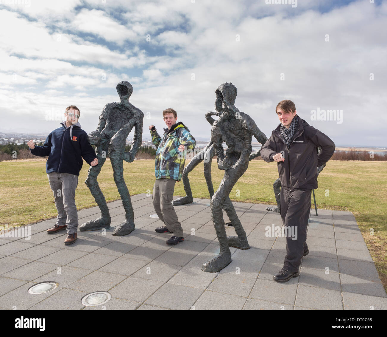 Teacher and students having fun by statues near The Pearl, Reykjavik, Iceland Stock Photo