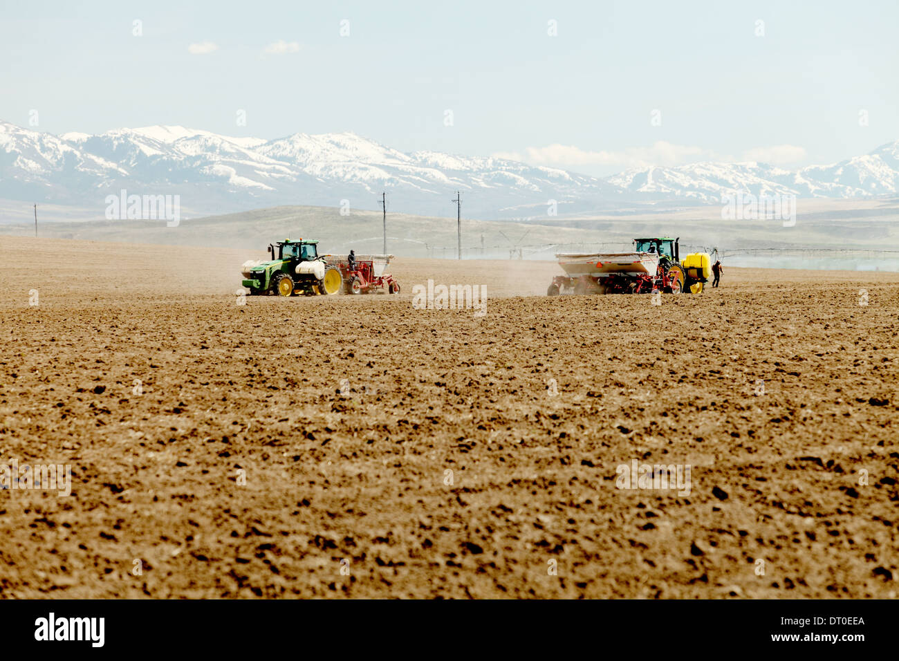 Tractors and other farm machinery working in the fields planting Famous