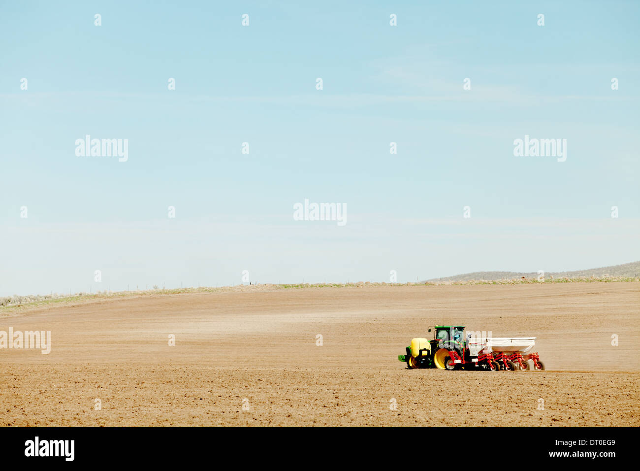 Tractors and other farm machinery working in the fields planting Famous