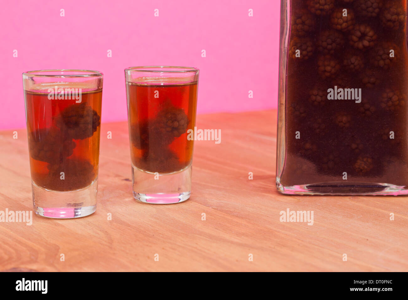 Bottle and two shots of homemade blackberries liqueur Stock Photo Alamy