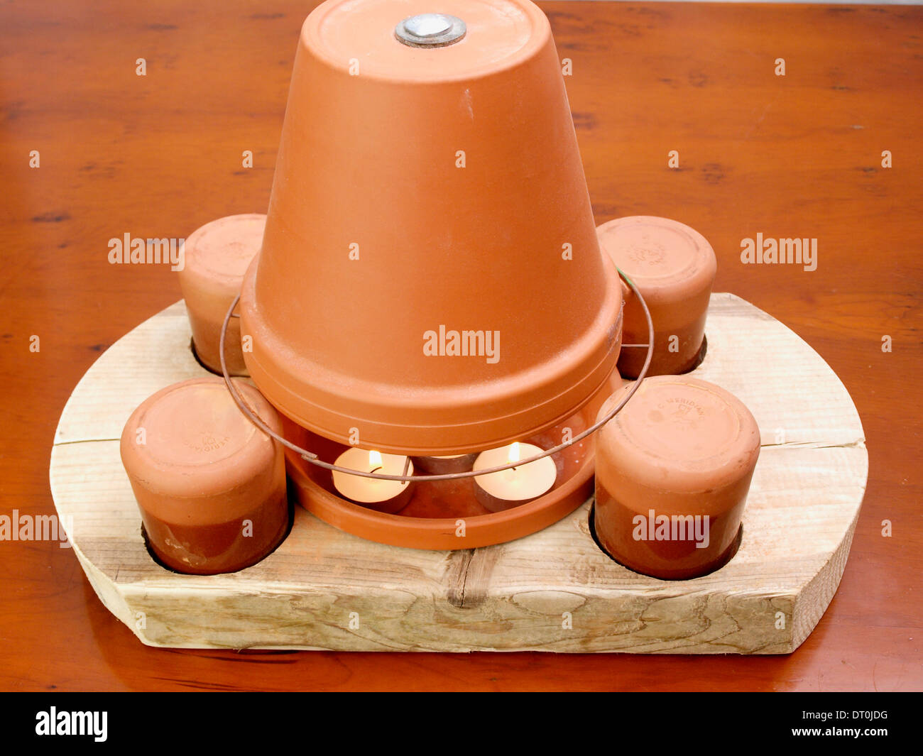 Tea light candle and flower pot heater Stock Photo Alamy