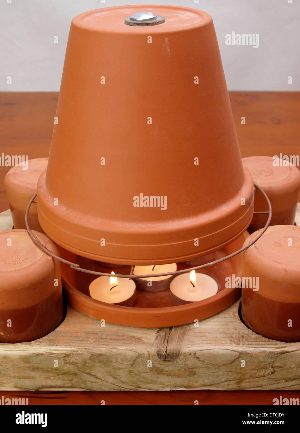 Tea light candle and flower pot heater Stock Photo Alamy