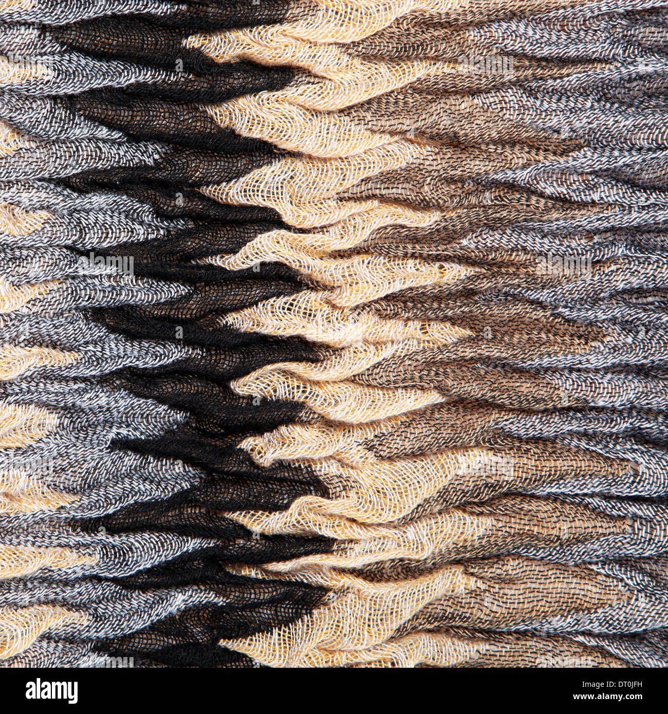 Luxurious knit textured ruched fabric with a distinctive zig-zag striped pattern in shades of brown and grey Stock Photo