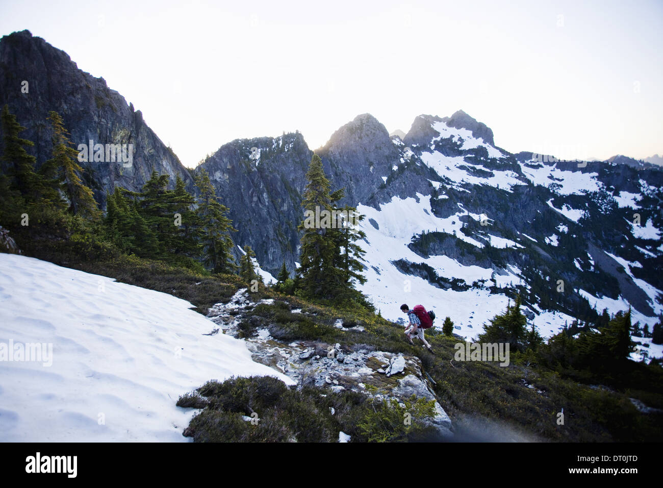 Washington state USA man hikes snow patch Cascades Washington USA Stock Photo