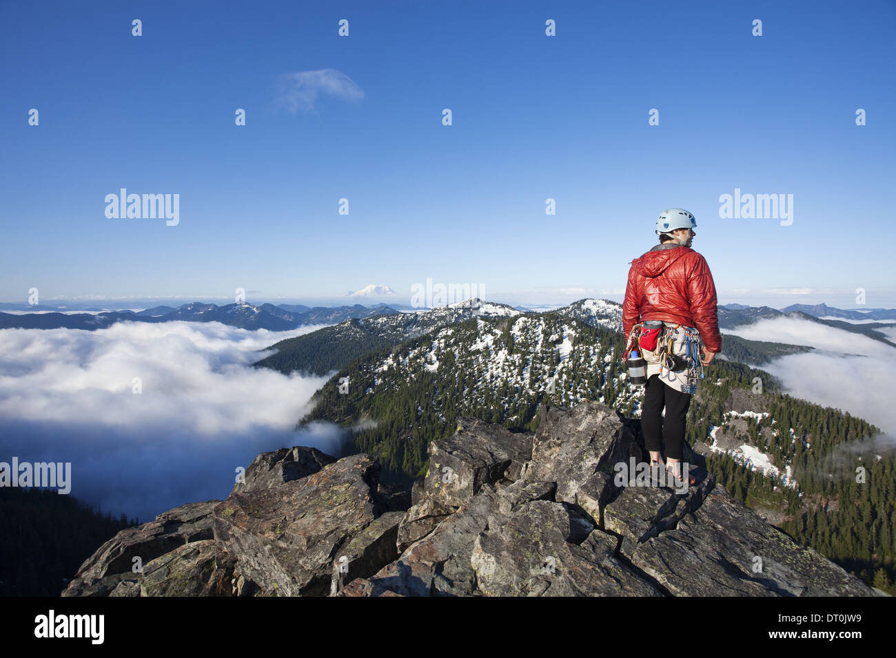 Washington state USA rock climber peak climbing to the top with rope Stock Photo