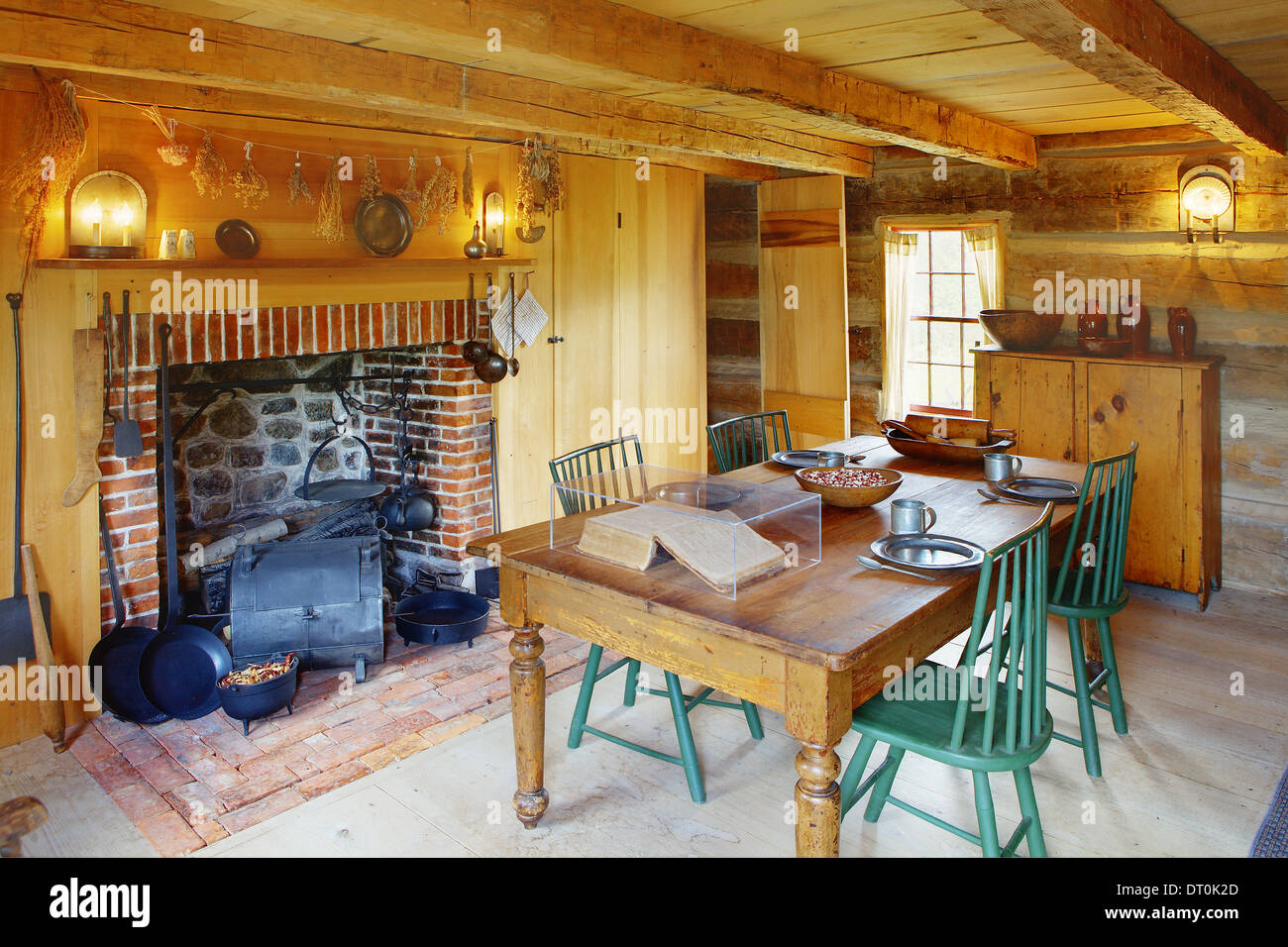 The dining room and living space of a primitive colonial style home. Stock Photo