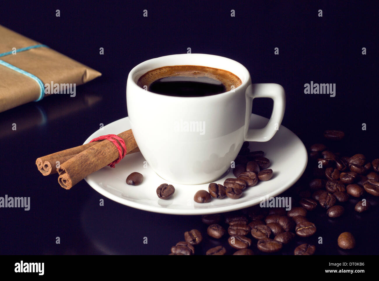 white coffee cup with natural roasted beans and gift on table Stock Photo