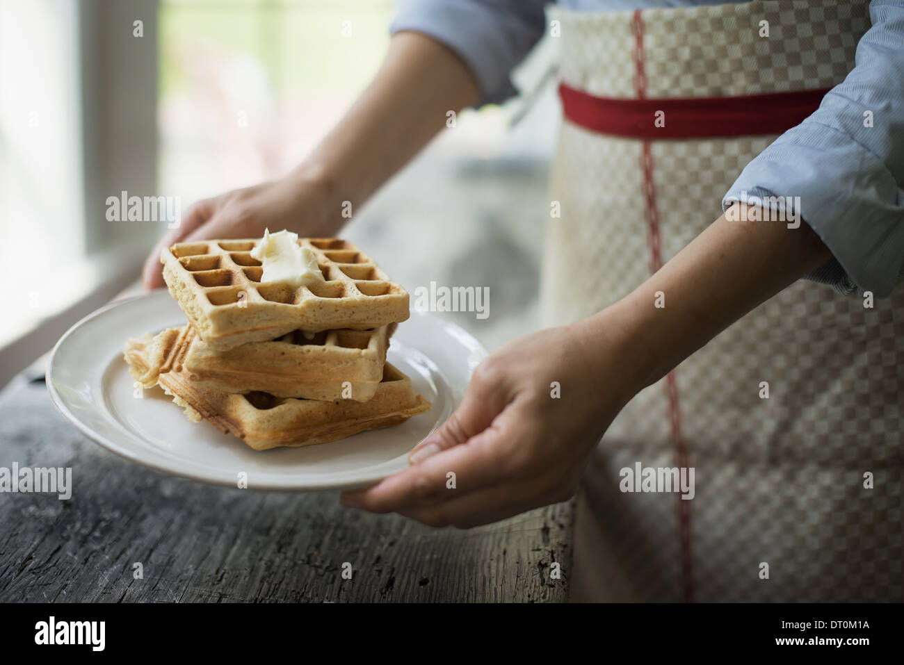 Woodstock New York USA woman plate of fresh cooked waffles with cream Stock Photo