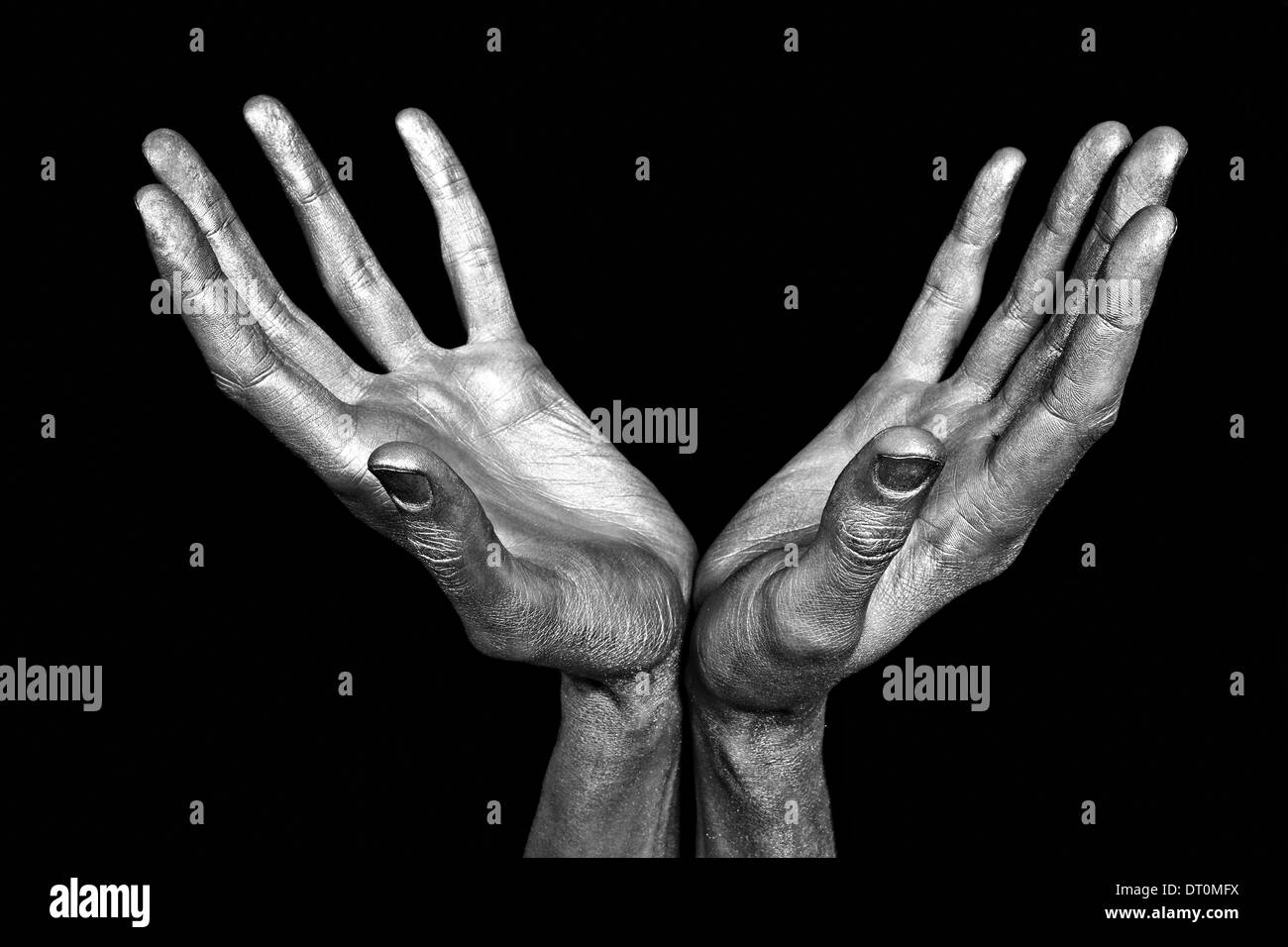 Silvery male hands isolated on black background Stock Photo