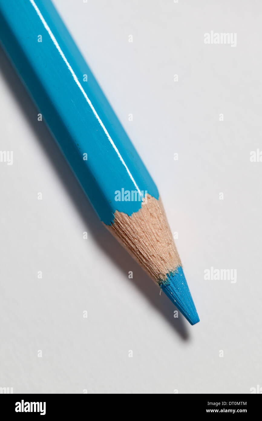 A light blue coloured pencil on a white paper background Stock Photo