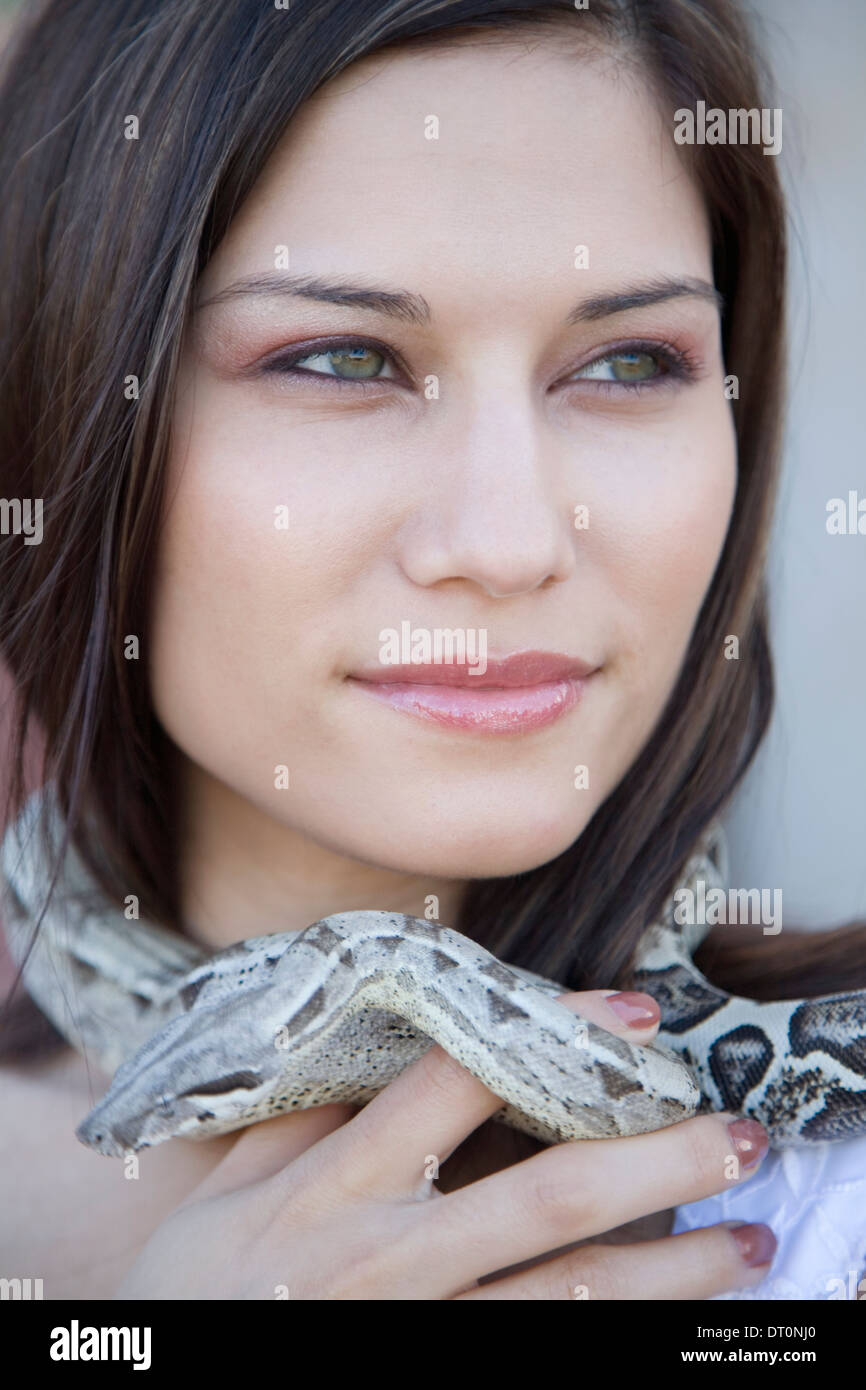 Portrait of woman with snake wrapped around neck Stock Photo