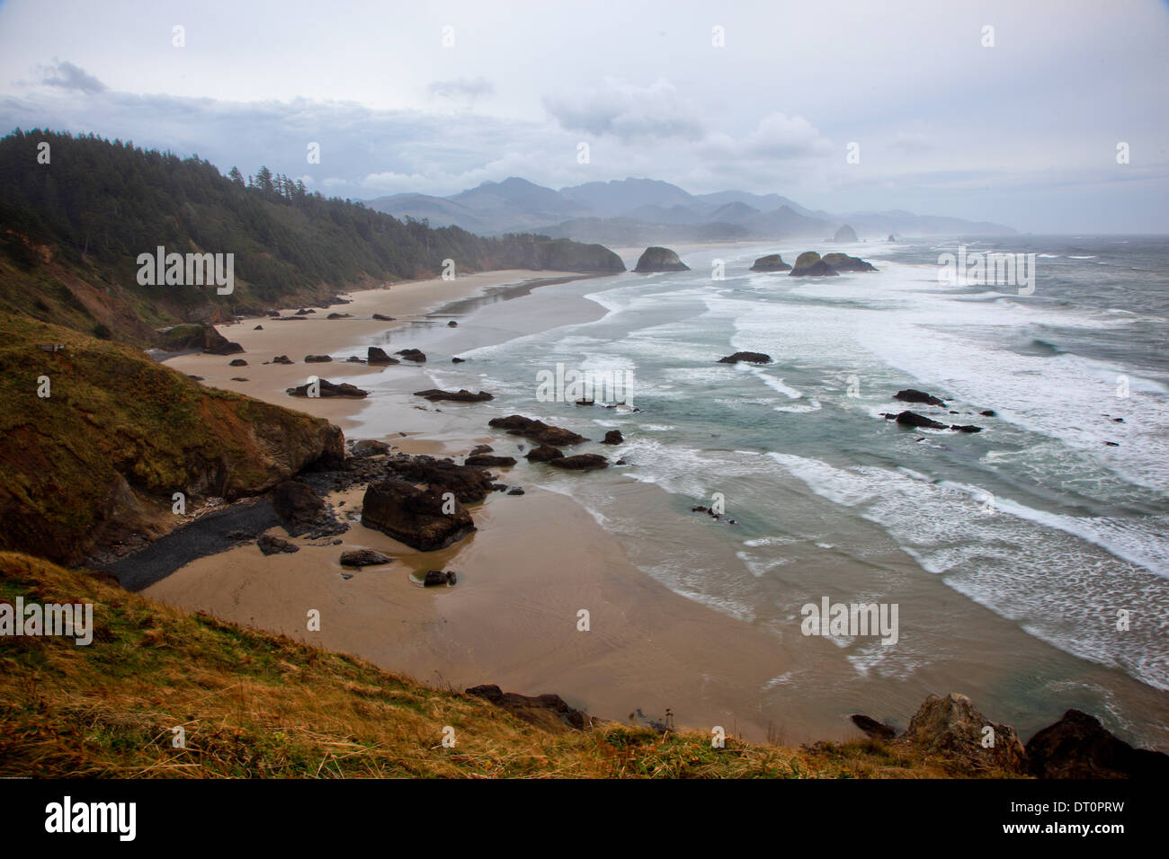 The tiny tourist town of Cannon Beach, Oregon on a rainy dark evening from Ecola State Park Stock Photo