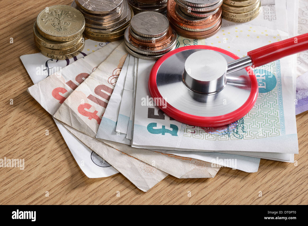 Stethoscope monitoring a pile of money Stock Photo