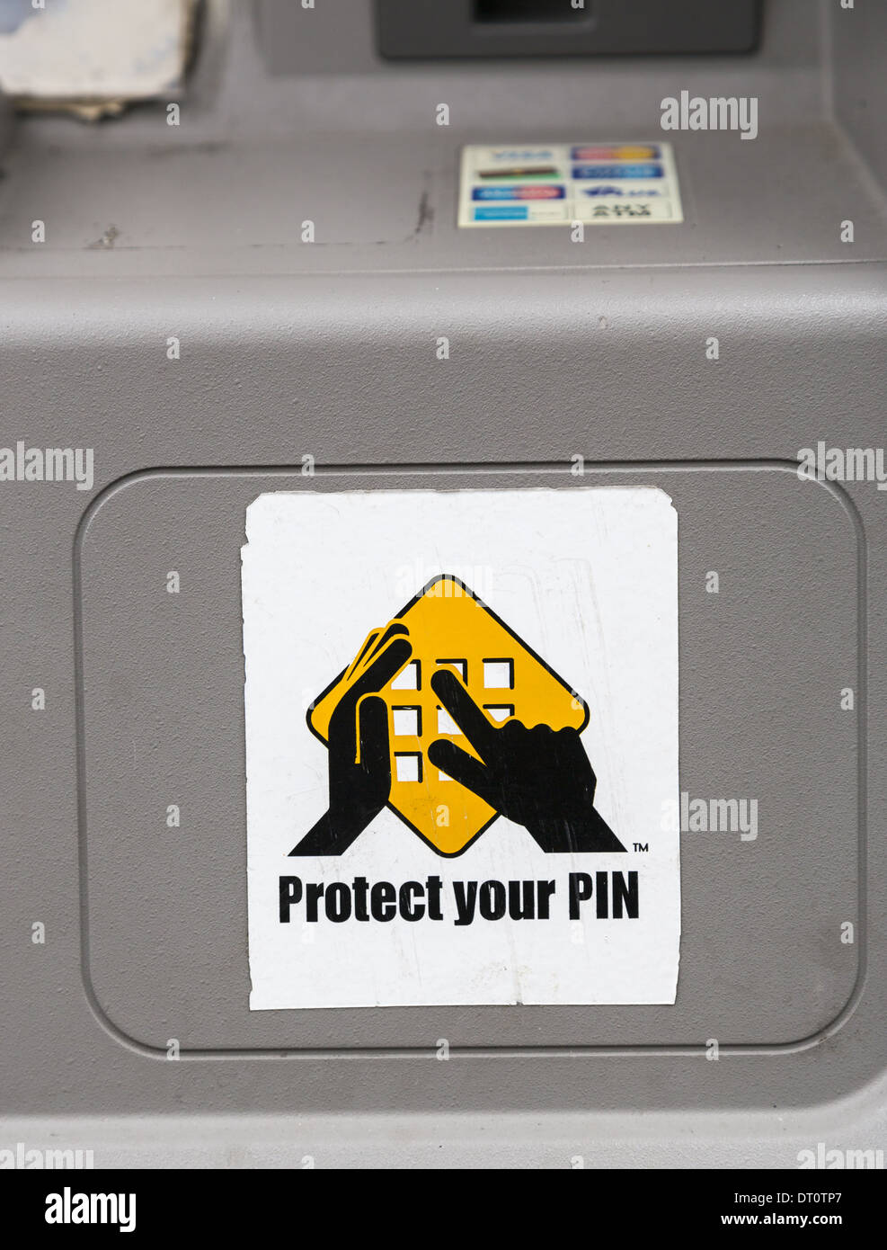 Sign on an ATM machine warning people to protect their pin Stock Photo