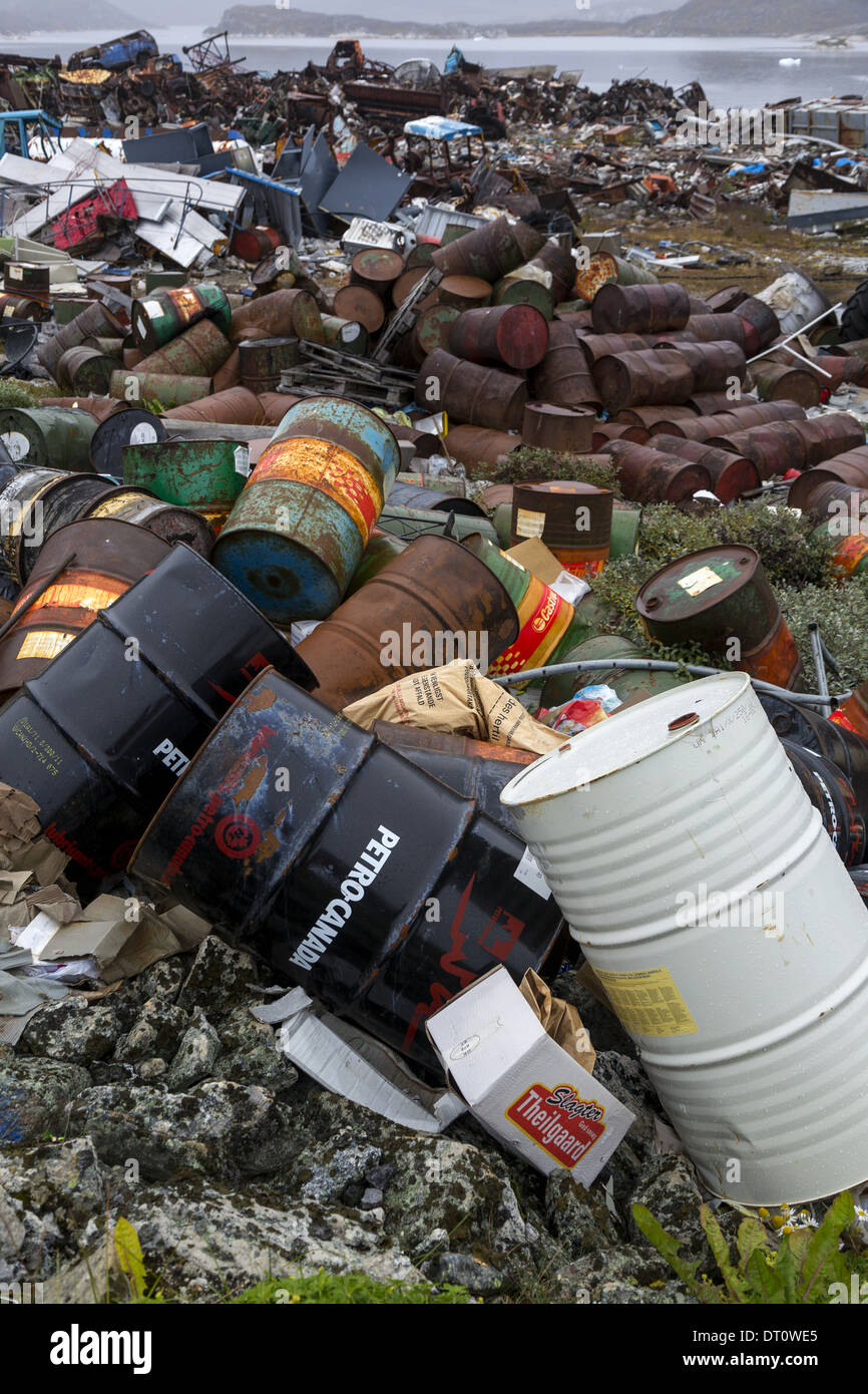 Discarded petro chemical drums at the recycling centre Nanortalik Greenland with eventual leak risk into ocean causing marine damage Stock Photo