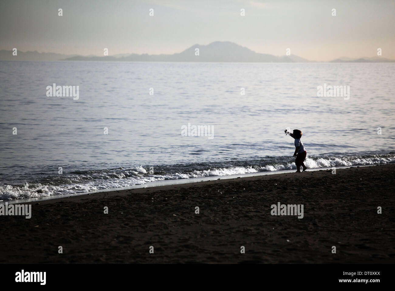 Small child alone on beach Stock Photo