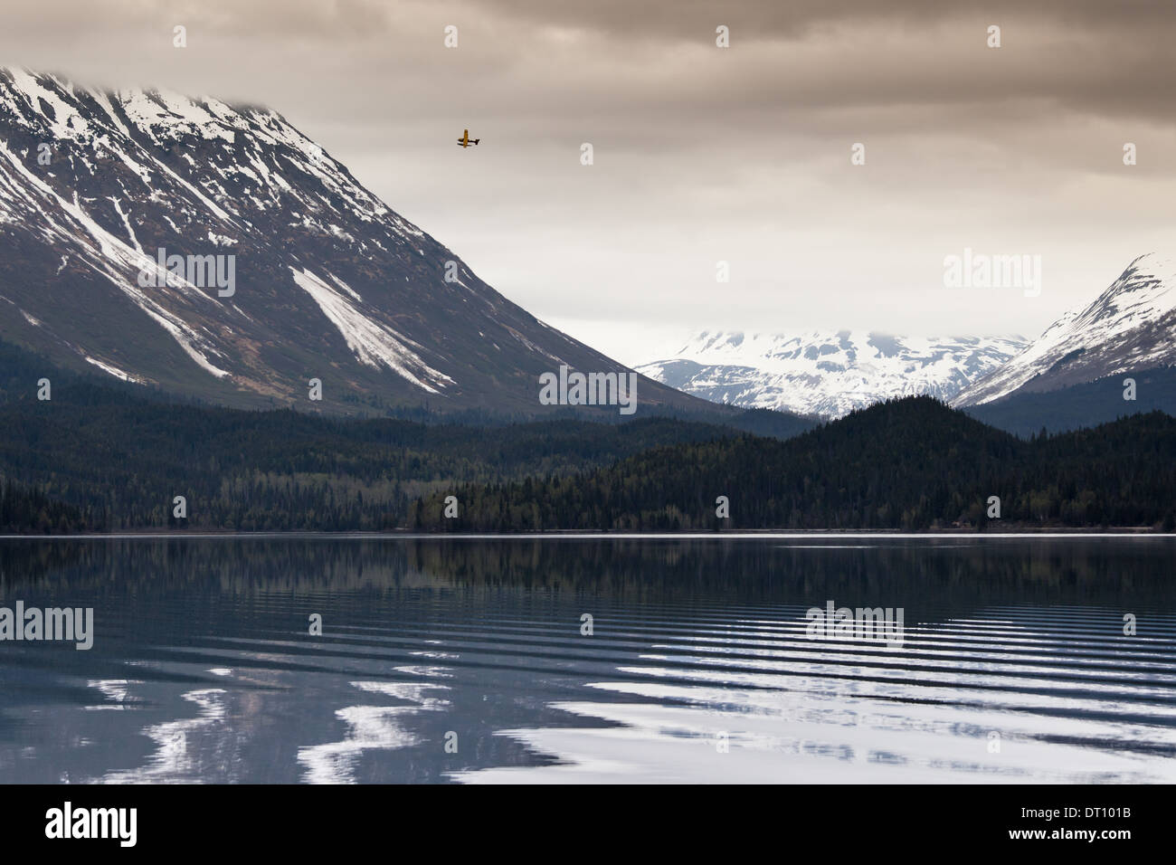 Float plane flying over Trail Lake near Moose Pass Alaska on a stormy