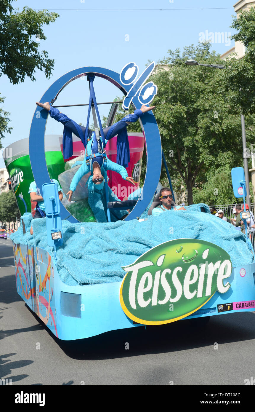 Acrobat on car with Teisseire logo in Tour de France caravan, Lyon, France, 2013 Stock Photo